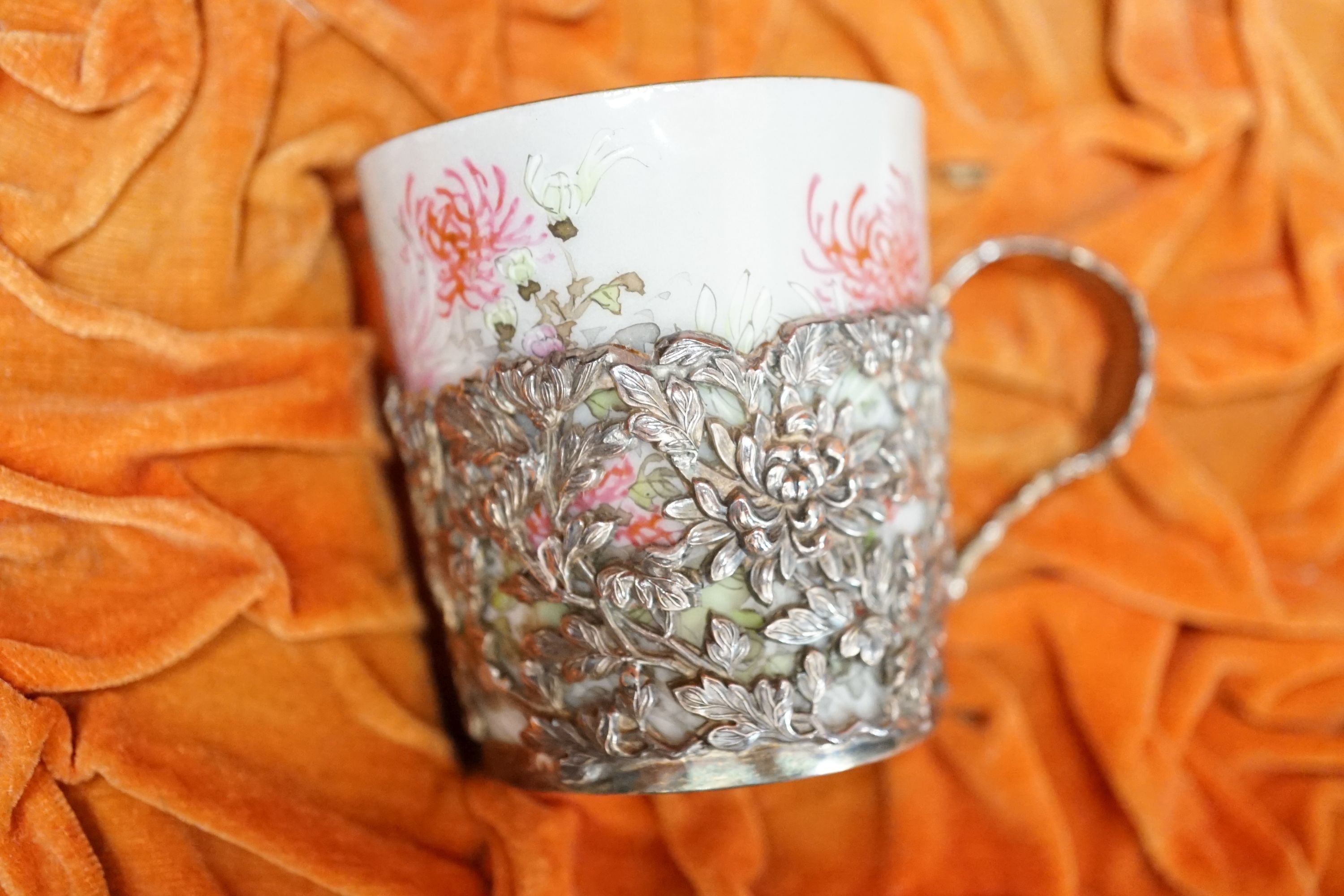 A cased Japanese white metal and eggshell porcelain six piece coffee set, maker’s mark only, case 39.5 cm wide